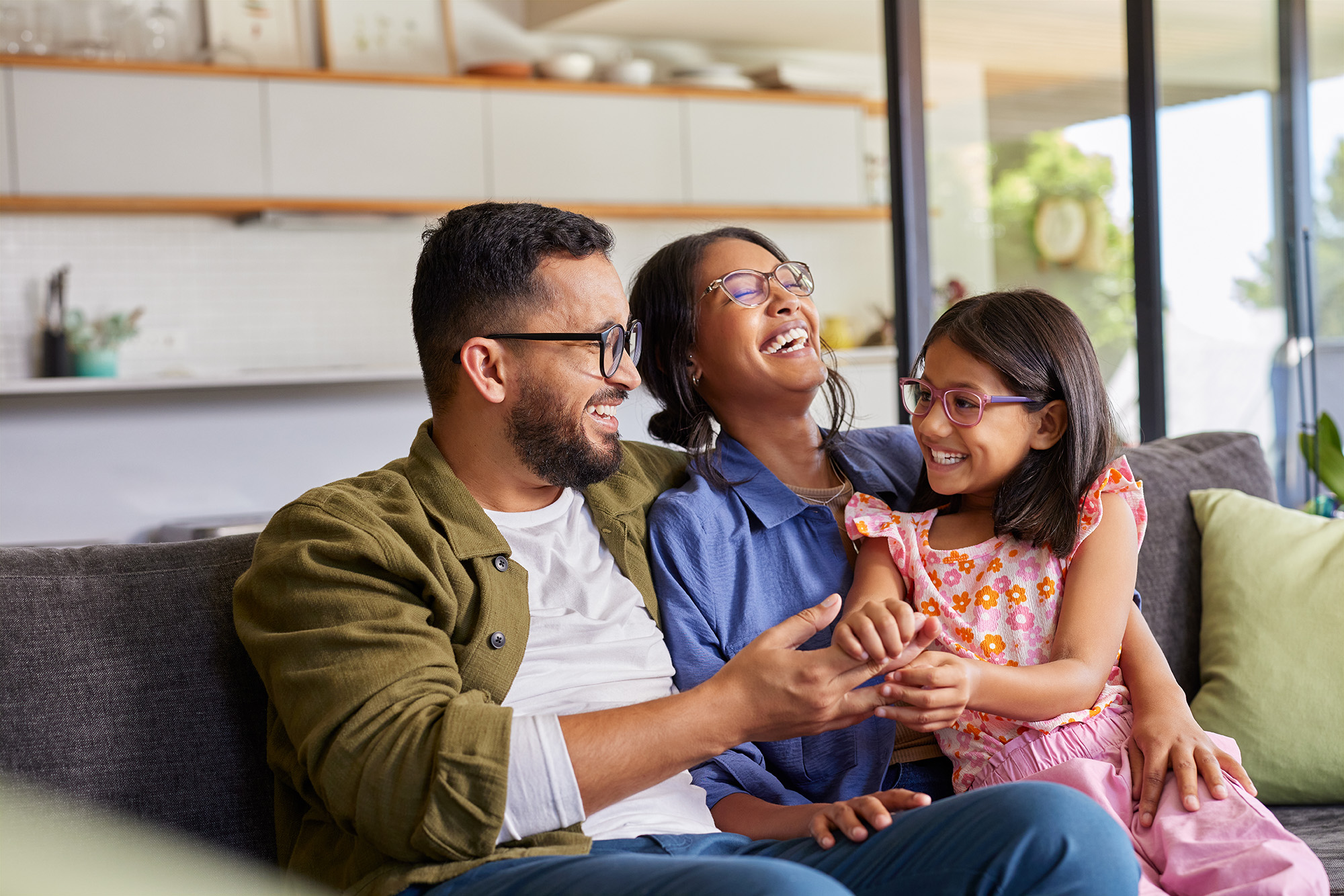 family sitting on a couch laughing
